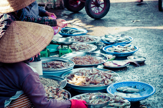 Sellers on the local market in Vietnam. Traditional food market in Hue, Vientam.