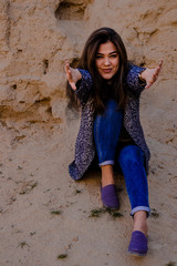 young lady stretching out her hands in the ancient ruins of Nisa