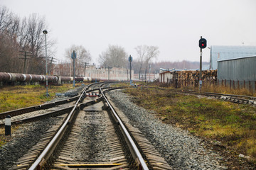 Fototapeta na wymiar railway in the industrial zone..empty rails with a semaphore, in anticipation of a freight train.