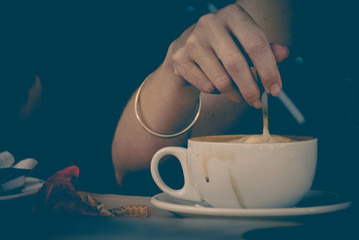 hand stirring coffee