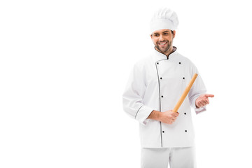 smiling young chef holding rolling pin and looking away isolated on white