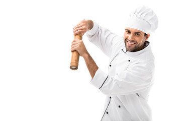 happy young chef with bamboo pepper mill isolated on white