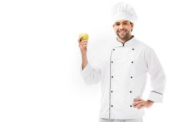 handsome young chef holding apple and looking at camera isolated on white