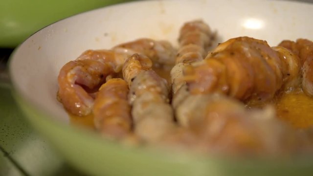 Meat of chicken skewers cooking in pan, cinematic closeup