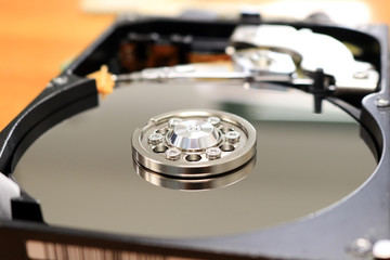 Open inside harddisk disassembled from the computer. Closeup magnetic tape in hard drive. 