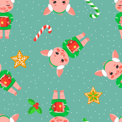 Naklejka premium Christmas seamless pattern with a cute little pig with cup of hot tee, gingerbread and candy on blue background. Vector illustration of a cartoon character of the sign of year 2019