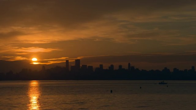 Vancouver Sunrise over English Bay 4K UHD. Sunrise over English Bay and the Vancouver skyline. 4K. UHD.