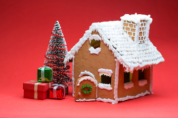 Cookie house and christmas tree on red background