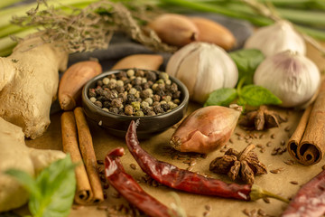 Spice collage - Mix of red, black and white pepper, garlic, shallots, spicy herbs, cinnamon, star anise, chili pepper, ginger, mint on a stone background