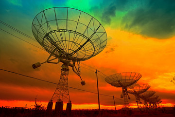 The silhouette of a radio telescope observatory