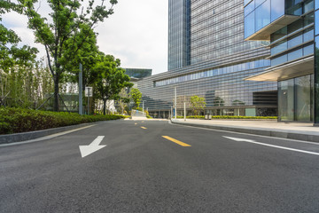 Obraz premium clean asphalt road through office block area, suzhou, china