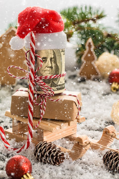     Money Christmas Gift with wooden sled. Christmas concept.
