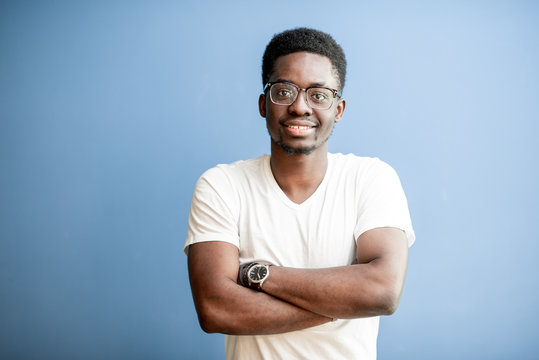 Portrait Of A Young African Man Dressed In White T-shirt Standing On The Colorful Background