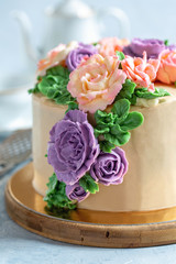 Cake decorated with buttercream flowers.