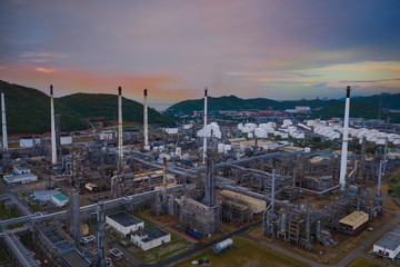 Aerial view of Sunset sky with  Industrial view at oil refinery plant form industry zone ,which factory - petrochemical plant, Shot from drone of Oil refinery.