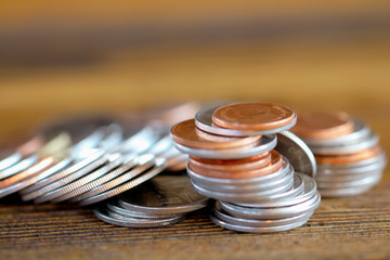 Row of coins on wood background for finance and Saving concept,Investment, Economy, Soft focus and dark style.