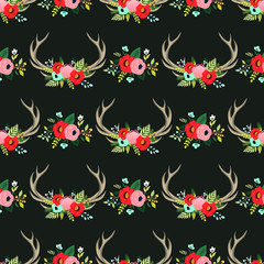 Vector seamless pattern with floral antlers in the bohemian style. Hand drawn deer horns decorated with flowers, leaves and herbs. Boho chic design elements