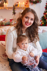 Obraz na płótnie Canvas Christmas family Mom and daughter. Merry Christmas and Happy Holidays card! Morning before Xmas background. Portrait loving family. Family preparation holiday food. Happy New Year! Christmas baby