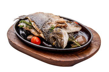 Dorada baked on stones in a cast iron skillet