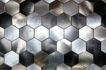 Modern background with a metal hexagons and a black outline. Macro shot