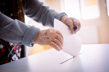 Person voting, casting a ballot