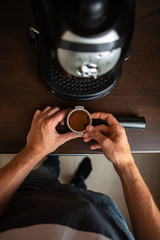 Fototapeta na wymiar Image of coffee maker, man hand pouring coffee