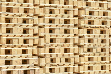 Stacked wooden pallets as background