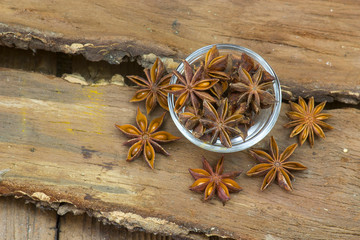 star anise in a bowl on wooden background