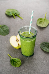 Green apple and healthy organic smoothie in glass with straw