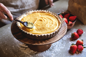 Woman making lemon meringue tart