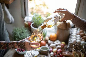 Women having a glass of white wine in the kitchen