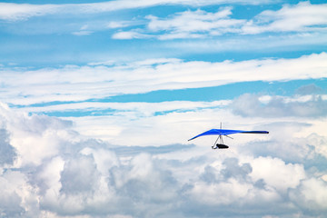 Light aircraft, deltaplane, against the sky with white clouds. deltaplane