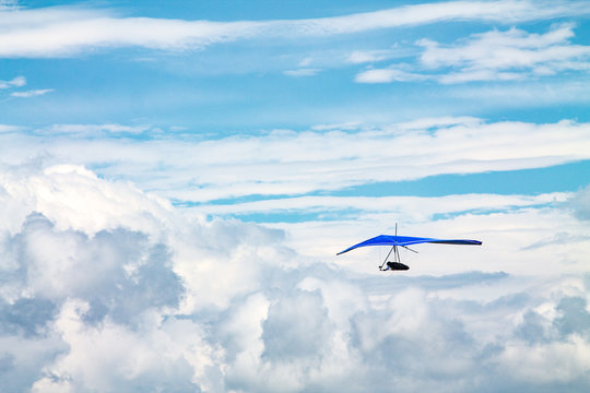Light aircraft, deltaplane, against the sky with white clouds. deltaplane