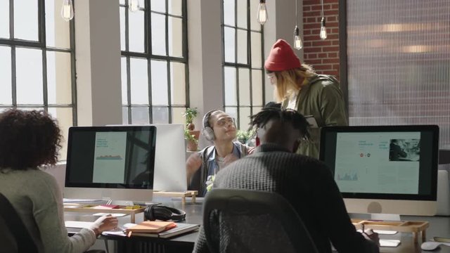 young business people working in startup office caucasian team leader woman pointing at computer screen showing colleague creative ideas training intern brainstorming discussing information