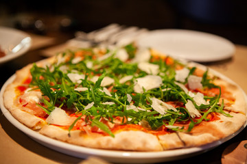 Delicious, cheesy and freshly baked Prosciutto di Parma pizza or pizza with Tomato, mozzarella,...