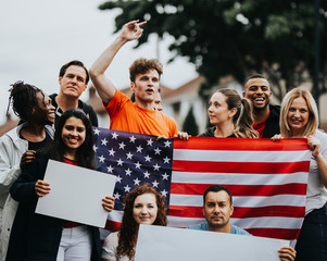 Group of activists showing American flag and blank posters