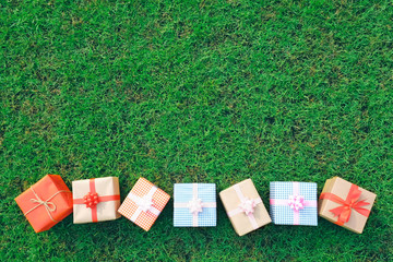 Gift box on the green lawn for Christmas, new year, valentine day or anniversary day and have copy...