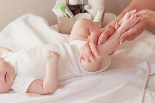 Baby and hands of mother, soft focus background