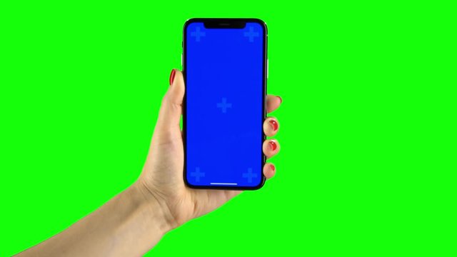 Holding hand a mobile smartphone blue screen. Green screen