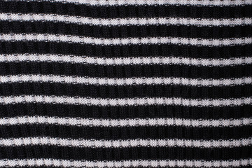 Black and white striped knitted fabric. Close up. Fashionable concept