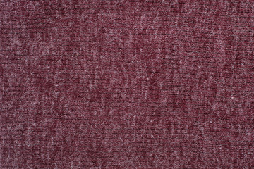 Burgundy knitted fabric. Close up. Fashionable concept