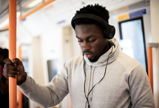 Standing passenger listening to music on the train