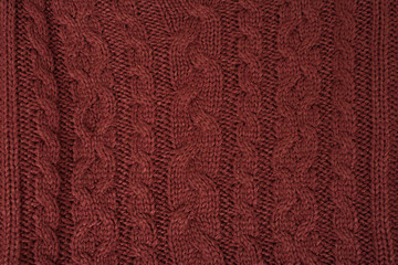 Brown knitted fabric, pigtail. Close-up