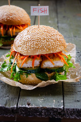 fish burger with marinated carrots and fresh vegetables