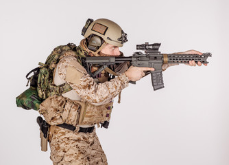 Special forces United States soldier or private military contractor holding rifle. Image on a white background.