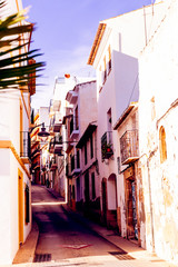Fototapeta na wymiar Mediterranean architecture in Spain. Cozy streets of the old town of Xavia or Javea.