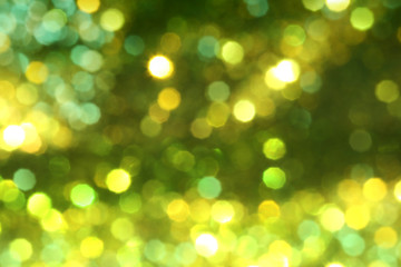 Christmas abstract gold bokeh background with light color in blur.