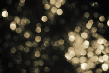 Christmas abstract gold mix black bokeh background with light color in blur.