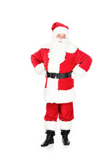santa claus looking at camera with arms akimbo isolated on white