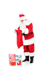 santa claus with gift boxes and bag isolated on white